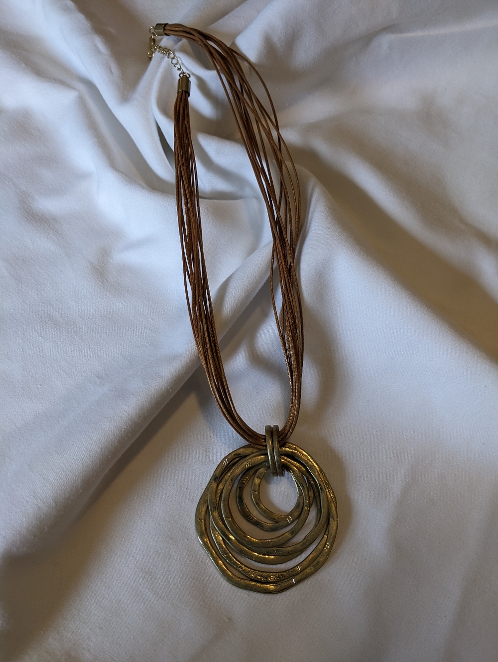 Multi-Strand Brown Necklace with Layered Gold Rings Pendant